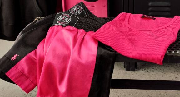 Black and pink satin boxing shorts and folded hot pink tee.
