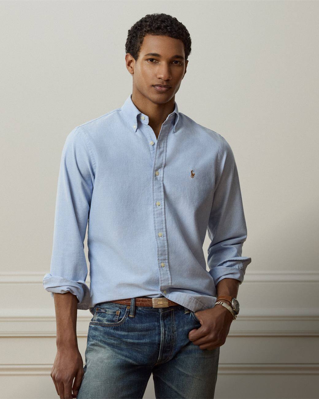 Man wears Classic Fit blue button-down shirt.